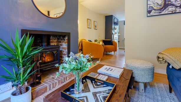 A cozy living room with a fireplace, a coffee table, and a sofa. - 3 Bed in Canterbury (oc-86139) (Canterbury)