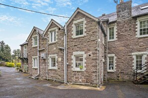 A stone building with multiple windows and a staircase. - 9 Bed in The Dardy (oc-t28942) (Crickhowell)