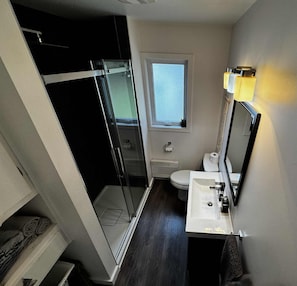 Shower, hair dryer, towels, toilet paper