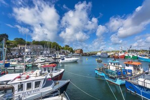 A harbor with various boats docked, buildings in the background, and a clear sky. - 3 Bed in Trevone (oc-c29020) (Trevone)