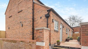 A brick building with a sign reading 'FRUIT TREE COTTAGES.'