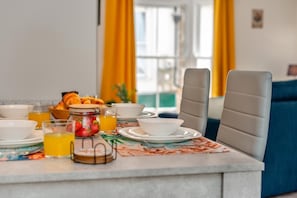 A breakfast setup with croissants, a fruit jar, and orange juice on a table. - 2 Bed in St. Ives (oc-e28156) (St Ives)