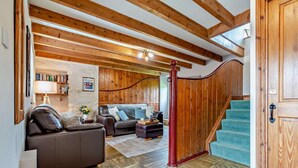 A spacious living area with a wooden staircase leading to a second floor. - 2 Bed in Port Mulgrave (oc-t29066) (Port Mulgrave)