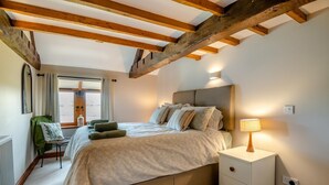 A bedroom with a bed, bedside table, lamp, and a chair. - 4 Bed in Heywood (oc-t29040) (Westbury)