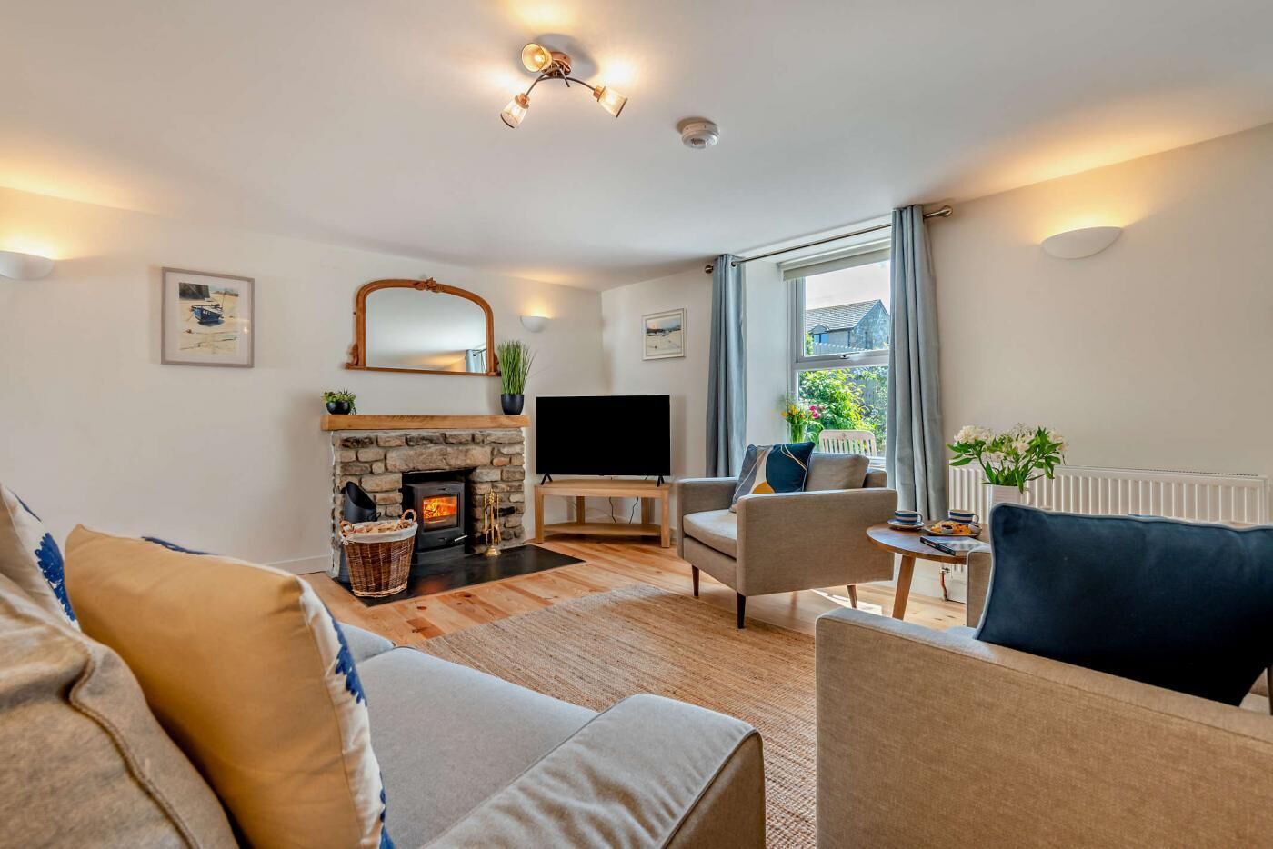 A cozy living room with a fireplace, comfortable seating, and a television.