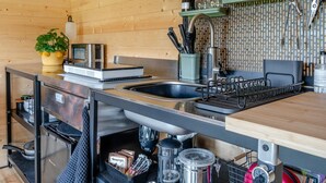 A modern kitchen with a stainless steel sink, a built-in oven, and a variety of kitchen utensils and appliances. - 1 Bed in Cilycwm (oc-t29297) (Cilycwm)