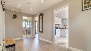 A spacious hallway with a wooden floor leading to a kitchen area. - 2 Bed in Oxborough (oc-r29291) (Oxborough)