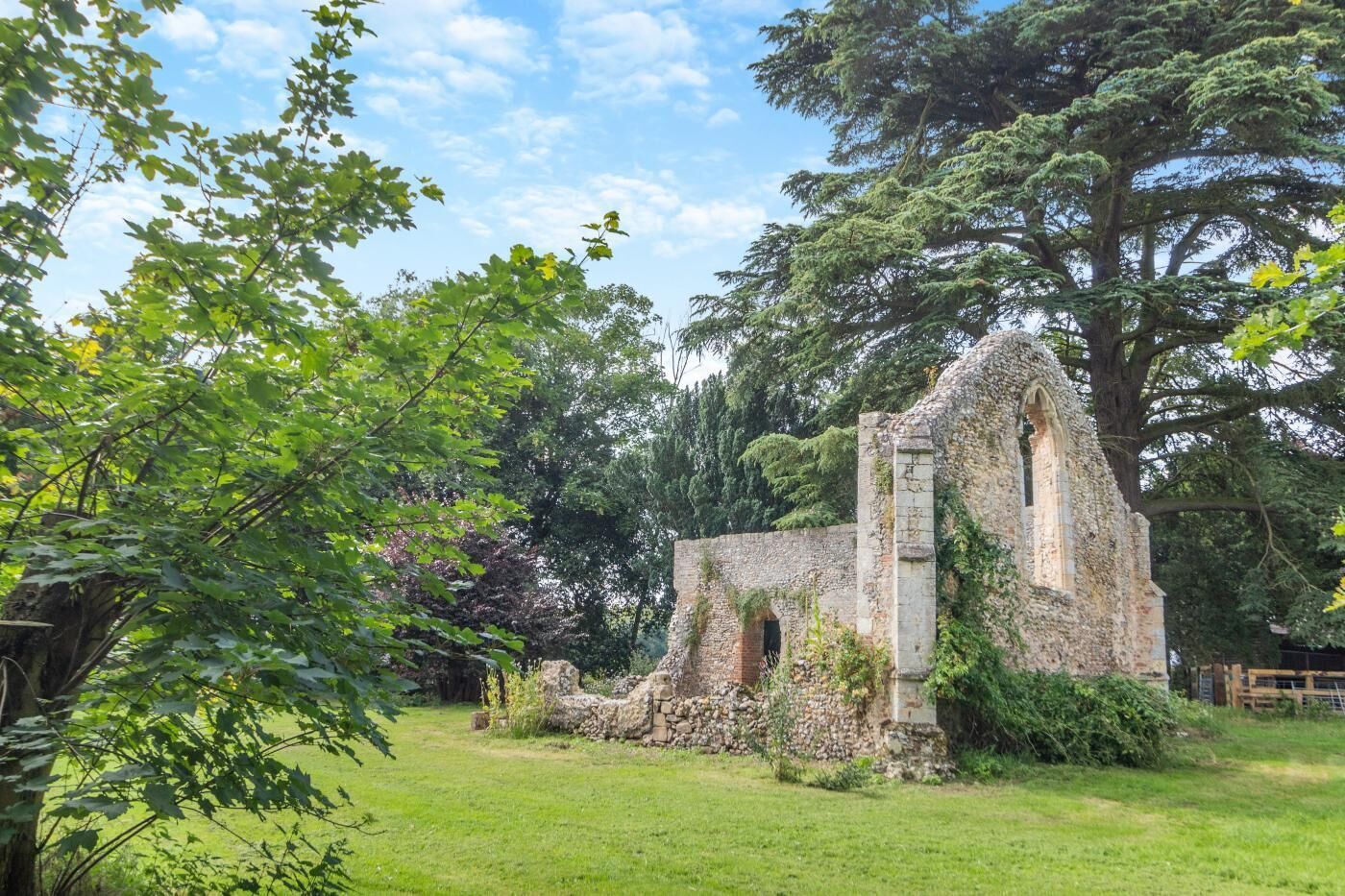 An ancient stone structure surrounded by lush greenery.