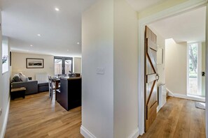 A modern interior with a kitchen, dining area, and living room.