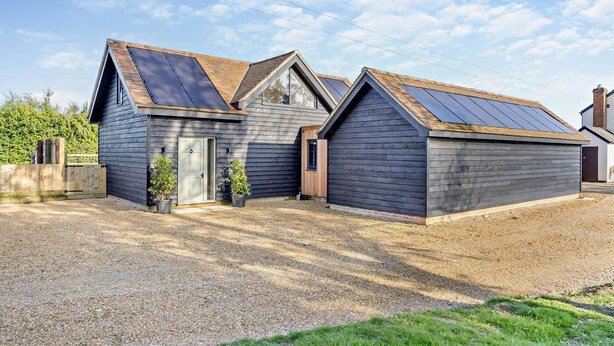 A modern two-story building with a gravel driveway and a wooden fence. - 2 Bed in Feering (oc-p29293) (Feering)
