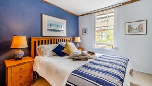 A bedroom with a bed, two bedside tables, a window with a view, and artwork on the walls. - 1 Bed in Chilham (oc-t29281) (Chilham)