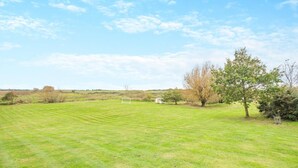 A grassy field with a white goalpost and a small shed. - 5 Bed in Morston (oc-s29448) (Morston)