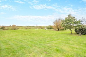 A grassy field with a white goalpost and a small shed. - 5 Bed in Morston (oc-s29448) (Morston)