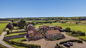A large estate with multiple buildings, a paved driveway, and surrounding green fields. - 3 Bed in Lower Bodham (oc-p29593) (Bodham)