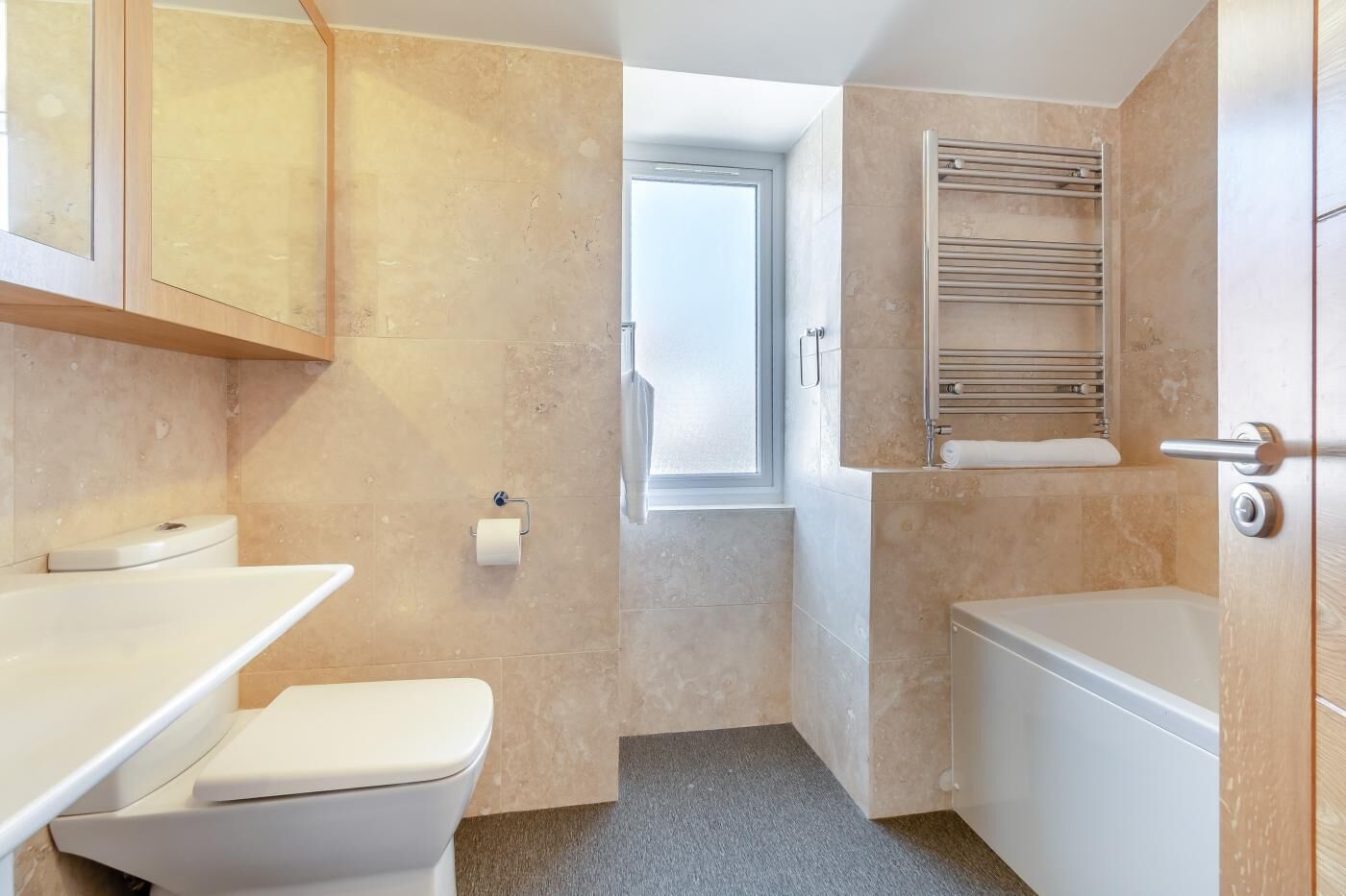 A compact bathroom with a toilet, sink, and bathtub.