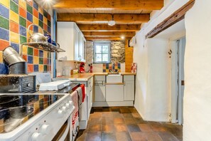 A kitchen with a stove, oven, and tiled backsplash.