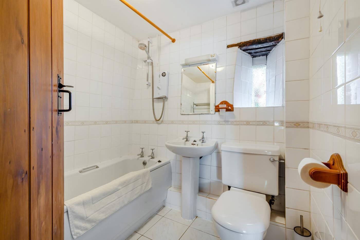A bathroom with a bathtub, sink, toilet, and a shower.