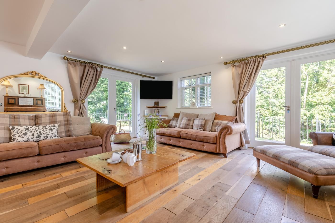 Ein geräumiges Wohnzimmer mit zwei Sofas, einem Couchtisch und einem Fernseher.
