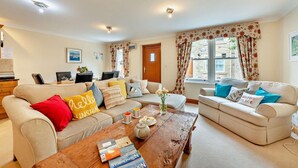 A cozy living room with two sofas, a coffee table, and a dining area. - 1 Bed in Beadnell (oc-l29758) (Beadnell)