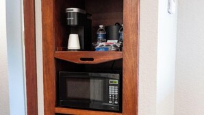A compact kitchenette with a coffee maker, microwave, and a small refrigerator. - Executive King Room with with Modern Amenities & Breakfast (Hillsdale)
