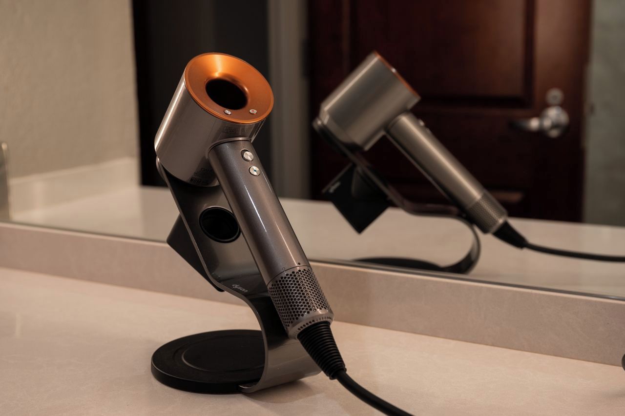 A microphone on a stand with a cord, placed on a flat surface.