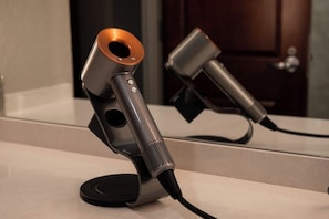 A microphone on a stand with a cord, placed on a flat surface. - Executive King Suite with Sleeper Sofa. Breakfast Included (Hillsdale)