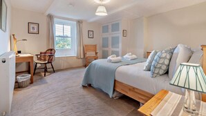 A bedroom with a bed, a desk, a chair, a window, and a lamp. - 3 Bed in Gunnerside (oc-e26693) (Ivelet)
