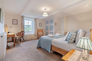 A bedroom with a bed, a desk, a chair, a window, and a lamp. - 3 Bed in Gunnerside (oc-e26693) (Ivelet)
