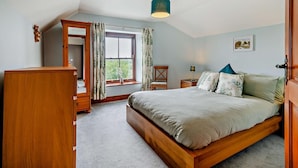 A bedroom with a wooden bed, a nightstand, a dresser, a window with curtains, and a ceiling light. - 2 Bed in Loveston (oc-l29792) (Reynalton)