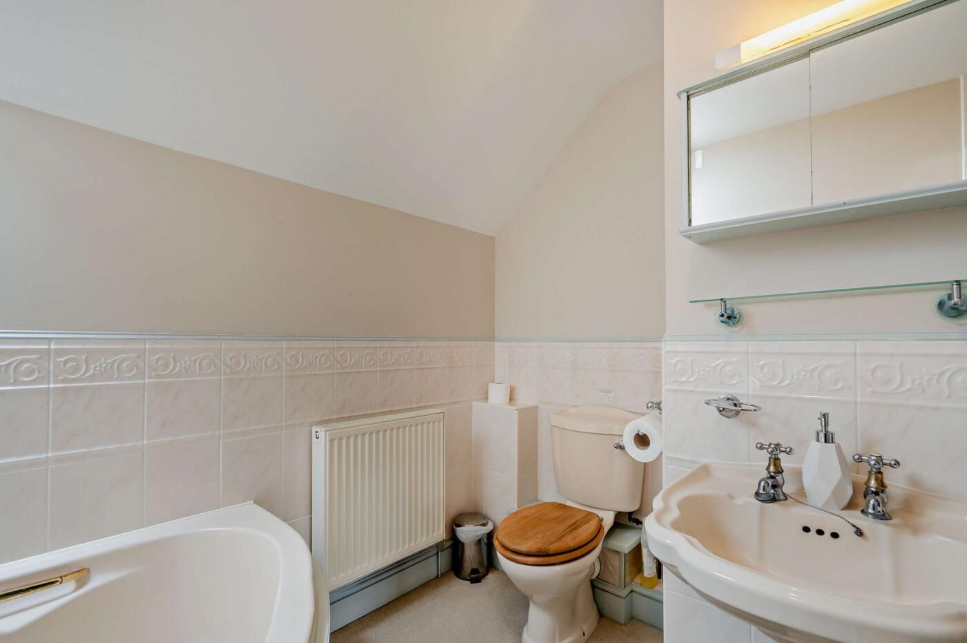 A bathroom with a bathtub, toilet, and sink.