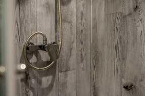 A shower with a hose and a control valve against a wooden wall. - 1 Bed in Two Waters Foot (oc-w29855) (Broadoak)
