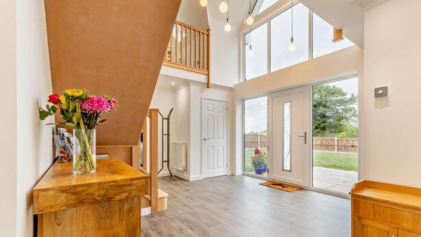 A spacious room with a wooden floor, a large window, and a view of the outdoors. - 4 Bed in Cawston (oc-p29906) (Cawston)