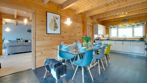 A wooden interior with a dining area, kitchen, and living space.