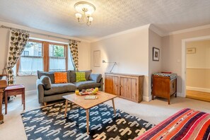 A living room with a sofa, coffee table, and a cabinet. - 2 Bed in Pathhead (oc-b29964) (Oxenfoord)