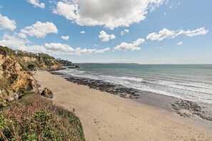 A coastal beach with rocky cliffs and a sandy shore. - 3 Bed in Duporth (oc-s29979) (Charlestown)