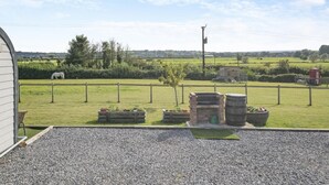 A rural property with a fenced pasture, a white horse, and a stone fireplace. - 1 Bed in Cross (oc-s29656) (Cross)