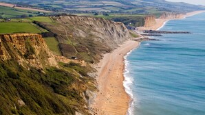A coastal cliff with a beach and ocean. - 2 Bed in Melplash (oc-r30043) (Melplash)