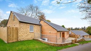 A row of stone and wooden cottages with metal railings and a paved driveway. - 2 Bed in Melplash (oc-r30043) (Melplash)