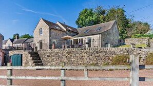 A stone building with a stone wall and a wooden fence in front. - 4 Bed in Ellastone (oc-11744sf) (Ellastone)