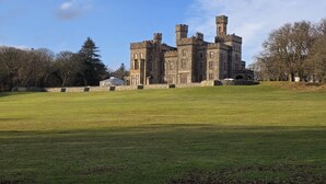A large, historic castle with multiple towers and a well-maintained lawn in the foreground. - 1 Bed in Reef (oc-r30134) (Uig)