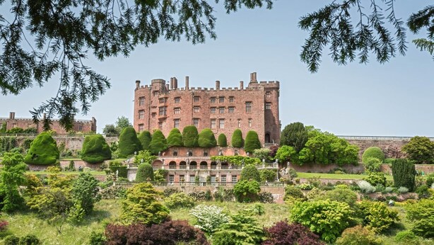 A large, historic castle with multiple towers and a well-maintained garden in front. - 1 Bed in Llanerfyl (oc-d30168) (Llanfair Caereinion)