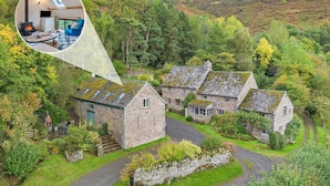 A stone house with a stone staircase leading to the entrance, surrounded by lush greenery and a hilly landscape. - 2 Bed in Cwmdu (oc-l30162) (Cwmdu)