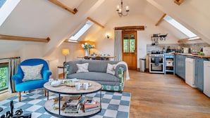 A cozy loft-style living room with a high ceiling, a dining area, and a kitchen. - 2 Bed in Cwmdu (oc-l30162) (Cwmdu)
