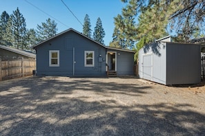 A single-story house with a front door, a small porch, and a garage.