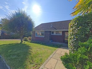 A single-story brick house with a tiled roof, a front lawn, and a tree. - 2 Bed in Norton (oc-l30264) (Freshwater)