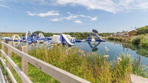 An outdoor water park with inflatable slides and play structures. - 4 Bed in Winnards Perch (oc-k30259) (Winnard's Perch)
