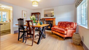 A living room with a fireplace, a dining table with chairs, and a sofa. - 2 Bed in Nacton (oc-c30257) (Nacton)