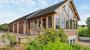 A traditional building with large windows, a sloped roof, and a stone foundation. - 2 Bed in Ellastone (oc-t30011) (Ellastone)