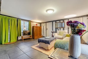 A bedroom with a bed, a sofa, a wooden wardrobe, a TV, and a window with curtains. - 2 Bed in Woodchurch (oc-b30323) (Woodchurch)