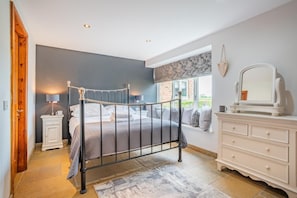 A bedroom with a bed, dresser, nightstand, and a window with a view. - 1 Bed in Crakehall (oc-o30357) (Kirkbridge)